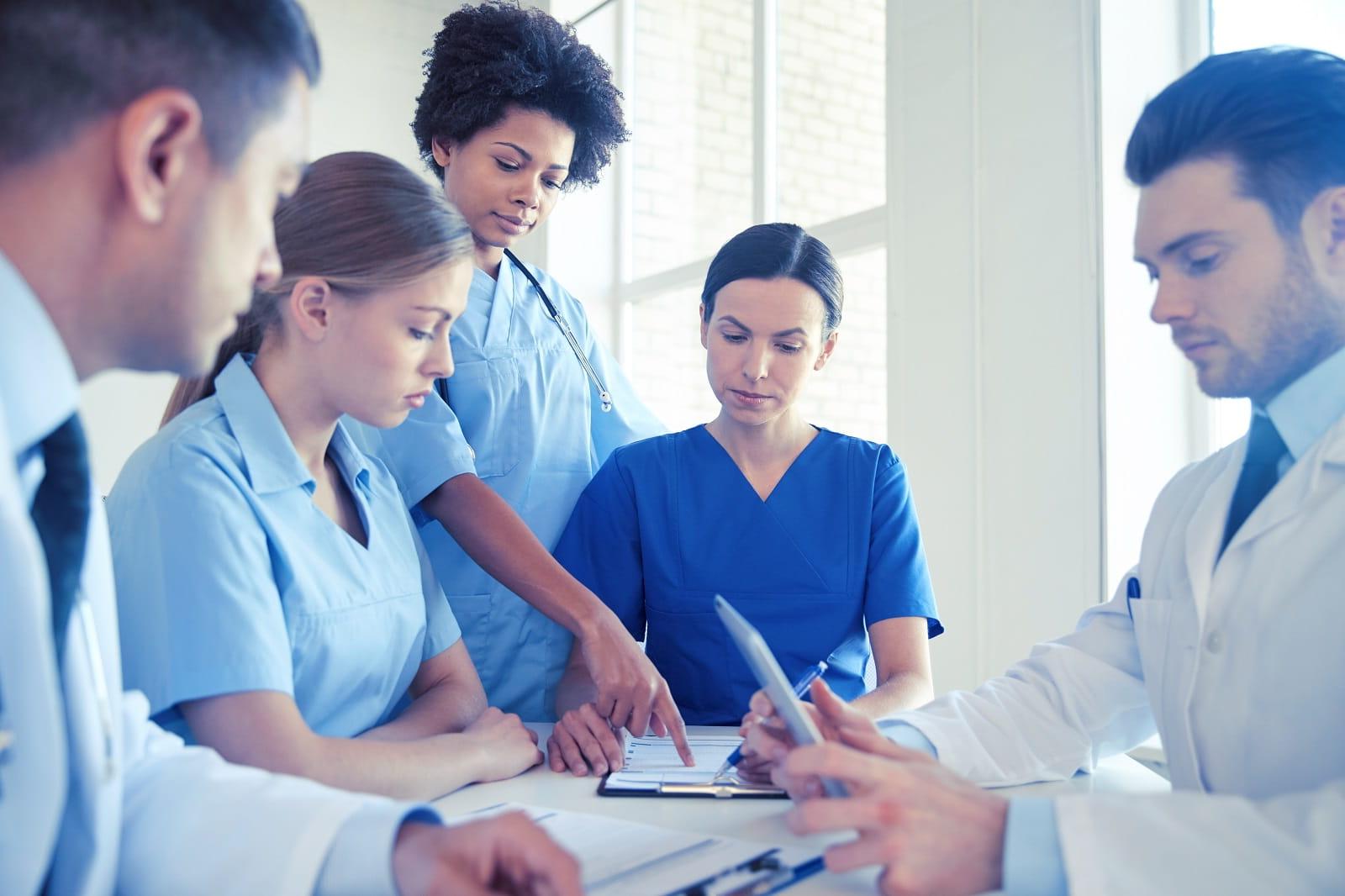 stock photo of group of medical workers looking at data